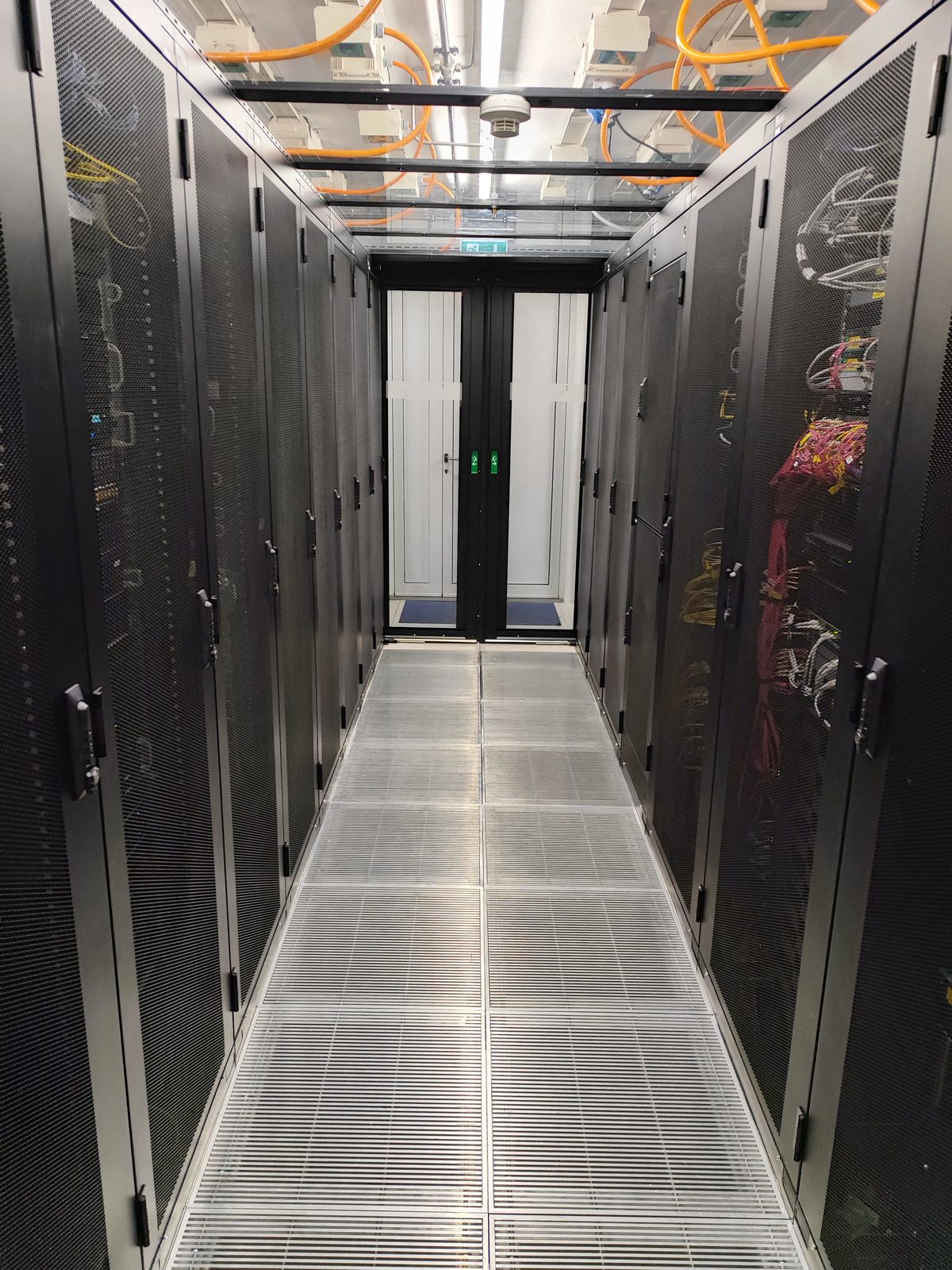 Cabling infrastructure and racks in the cold corridor of the standard colocation room